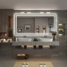 a bathroom with two sinks and a large mirror over it's sink area,