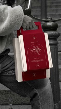 a person sitting on a bench with a book in their hand