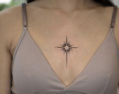 a woman's chest with a star tattoo on it