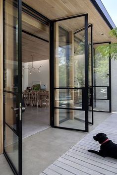 an instagram photo of a house with a dog sitting in the front door looking at it