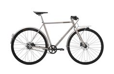 a silver bike with black spokes on the front and back wheel, against a white background