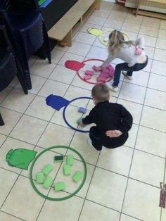 two children are playing with their toys on the floor