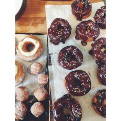 there are many donuts on the table ready to be eaten and served for consumption