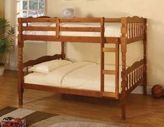 a wooden bunk bed sitting on top of a hard wood floor next to a window