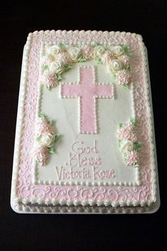 a cake that is decorated with flowers and a cross on the top it says god has victoria rose