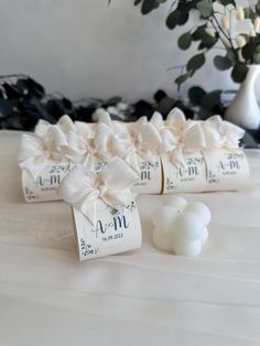 wedding favors with ribbons and flowers on the table