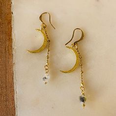 Embrace the mystery of the night sky with these delicate and dreamy dangle earrings. They feature golden crescents and dainty herkimer diamonds suspended on textured brass chain. Hilal is the Arabic name for the crescent moon. ⬩3mm x 4mm rough shape Herkimer Diamonds ⬩French hook-style brass wire ⬩1.5-inch dangle earring ⬩Herkimer Diamonds are great crystals for relaxation and meditation. This item will ship with gemstone information on the Santore Jewelry Card included with purchase. Crescent Earrings, Crescent Moon Necklace, Jewelry Card, The Night Sky, Herkimer Diamond, Gold Earrings Dangle, Moon Necklace, Jewelry Inspo, Brass Chain