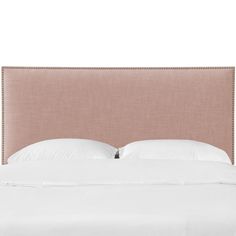 an upholstered headboard with white pillows