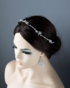 Crafted from shining starlight and exquisite antique silver, this headpiece exudes simplicity and elegance. Delicate vines adorned with shimmering crystal stars and intricate crystal beads create a stunning display of luxury. This headband measures about 15.5 inches long and 1 inch at the widest. Winter Wedding Headpiece, Silver Hair Accessories Prom, She Ra Oc, Diamond Headpiece, Bio Project, Silver Hair Accessory, Shadow Weaver, Silver Headpiece, Crystal Headpiece Wedding