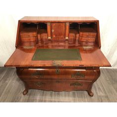 an old wooden desk with drawers on top