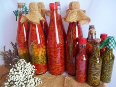 several bottles filled with different types of condiments on a burlap table