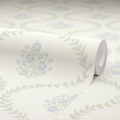 a roll of white paper with blue flowers on it