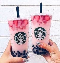 two starbucks drinks with strawberries in them