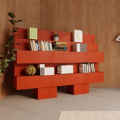 an orange book shelf with books on it and a potted plant in the corner