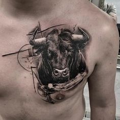 a man with a bull tattoo on his chest