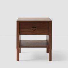 the side table is made out of wood and has a drawer on one side with an open drawer