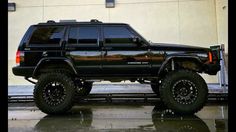 a black jeep parked in front of a building