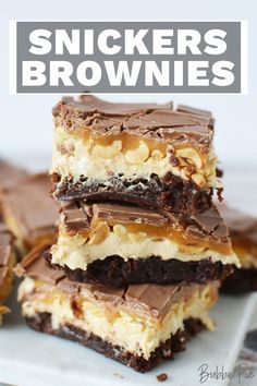 three pieces of snickkers brownies stacked on top of each other with peanut butter and chocolate