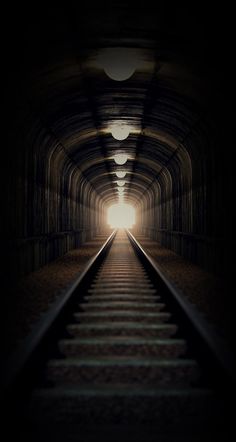 the light at the end of the tunnel shines brightly in the distance as it travels through