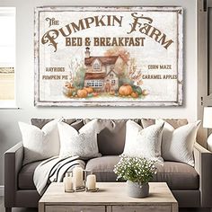 a living room filled with furniture and a sign on the wall above it that says pumpkin farm bed & breakfast