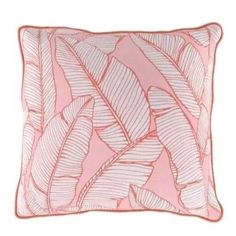 a pink and white pillow with leaves on it