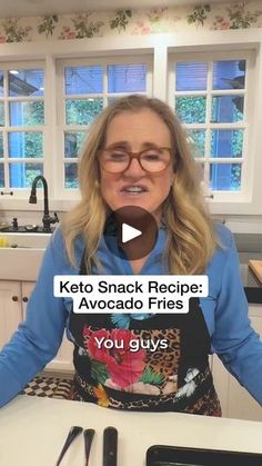 a woman sitting at a kitchen table with food in front of her and the words keto snack recipe avocado fries you guys