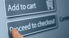 a hand presses the button on an electronic device that says, add to cart proceed to checkout