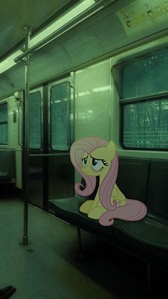 a pink pony sitting on top of a bench next to a window