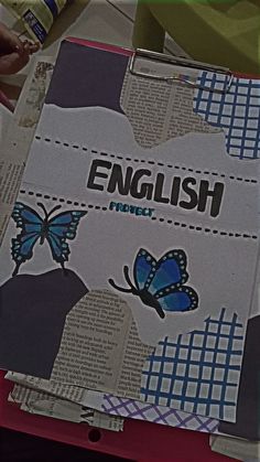 an open book with butterflies on it and the words english written in large letters above them