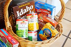 a wicker basket filled with different types of food and condiments on a tile floor