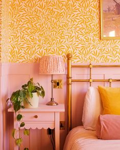 a bedroom with yellow and pink wallpaper