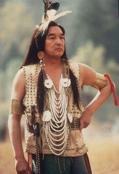 a native american man with feathers on his head