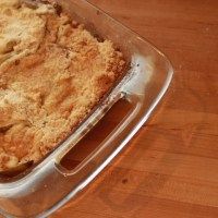 a casserole dish is sitting on a wooden table