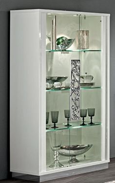 a white cabinet with glass shelves in it