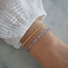 Add a special touch to your look. Our Birthstone Bead Collection styles are crafted with natural stones and three 14k gold rondelles strung on a coated wire for maximum durability. Wear your own birthstone—or a loved one’s—for a meaningful layer in any bracelet stack. Tanzanite is December's birthstone. Beaded Stacking Bracelets, Simple Bracelet Designs Gold, Birthstone Beaded Bracelets, Cute Beaded Bracelets, Mama Jewelry, Bracelet Business, England Summer, Bead Collection, Bracelet Stacks