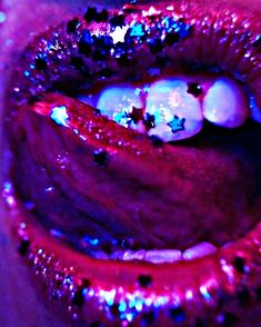 a close up view of the inside of a woman's mouth with stars on it