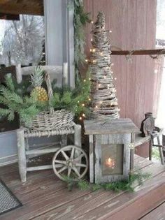 a small christmas tree sitting on top of a wooden table next to a basket filled with pine cones