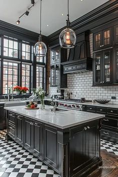 a kitchen with black and white checkered flooring, two pendant lights over the island