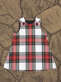 Beautiful handmade in Ayrshire Scotland Tartan Pinafore  Baby girls pinafore dress with button fastening at each shoulder, made in the Stewart Dress Tartan. Fabric is polyester/viscose and the black lining is polyester/cotton  Available in sizes 0-6 months approximate length 14.5 inches 6-12 Months approximate length 16.5 inches 1-2 years approximate length 18 inches 2-3 years approximate length 20.5 inches 3-4years approximate length 21.5 inches I try to keep my stock regularly topped up but sh Ayrshire Scotland, Scotland Tartan, Girls Pinafore Dress, Girls Pinafore, Baby Girls Dresses, Tartan Fabric, Tartan Dress, Pinafore Dress