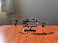 a toy car sitting on top of a wooden table