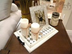 a table with candles and pictures on it