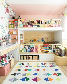 a child's playroom with lots of toys on the shelves and colorful rugs