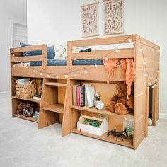 there is a bunk bed with bookshelves and stuffed animals on the bottom shelf