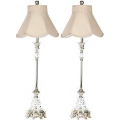 pair of crystal table lamps with white shades on each lamp and the shade is off