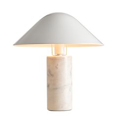 a white table lamp with a marble base and a light shade on it's top