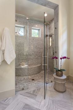 a walk in shower sitting inside of a bathroom