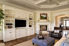 a living room filled with furniture and a flat screen tv mounted to the side of a wall