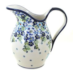 a blue and white flowered pitcher on a white background