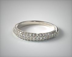 a white gold wedding band with rows of diamonds