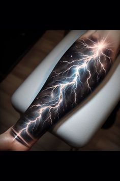 a man's arm with lightning tattoo on it